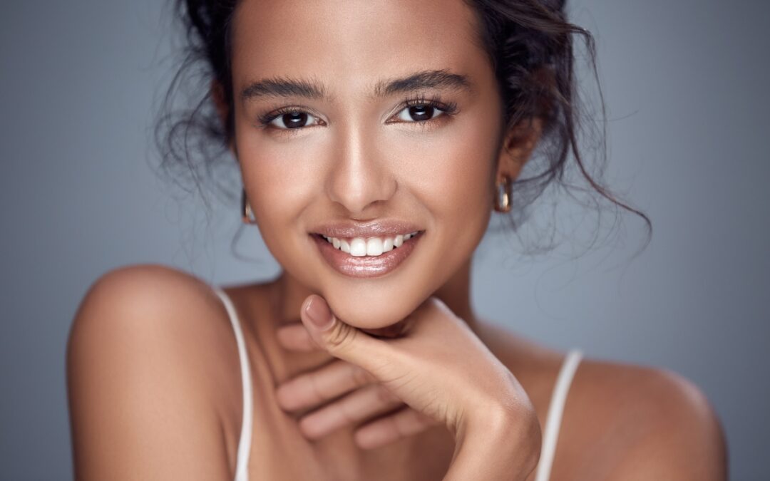 Woman with dark hair smiling brightly