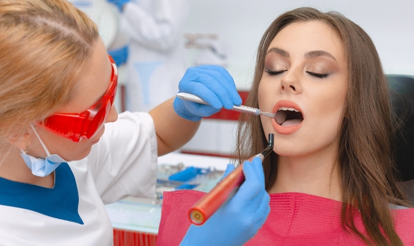 Dentist examining patient's open mouth