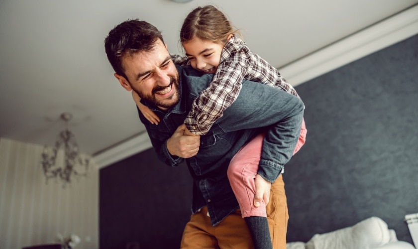 Father giving child piggyback ride