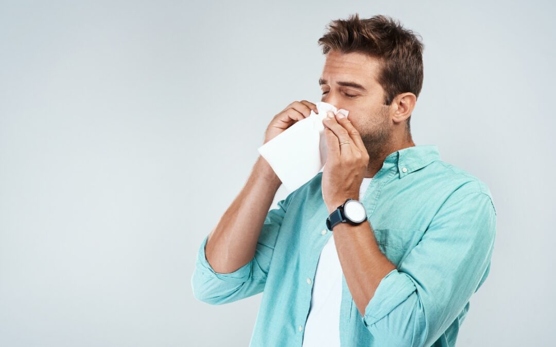 Man holding tissue to his nose