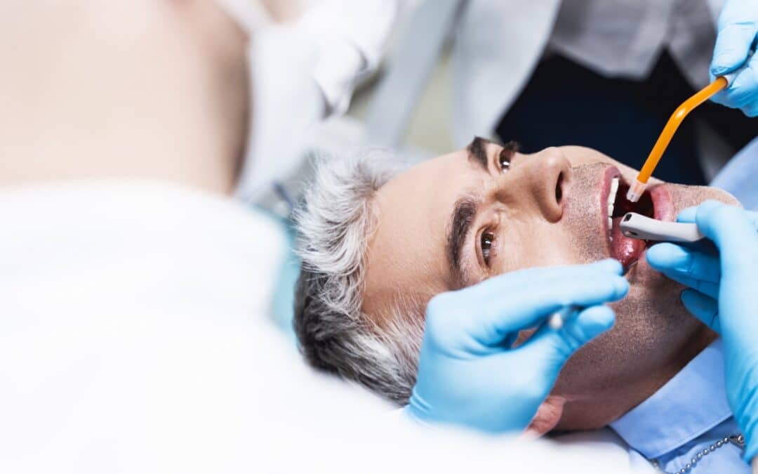 Man having dental exam with tools