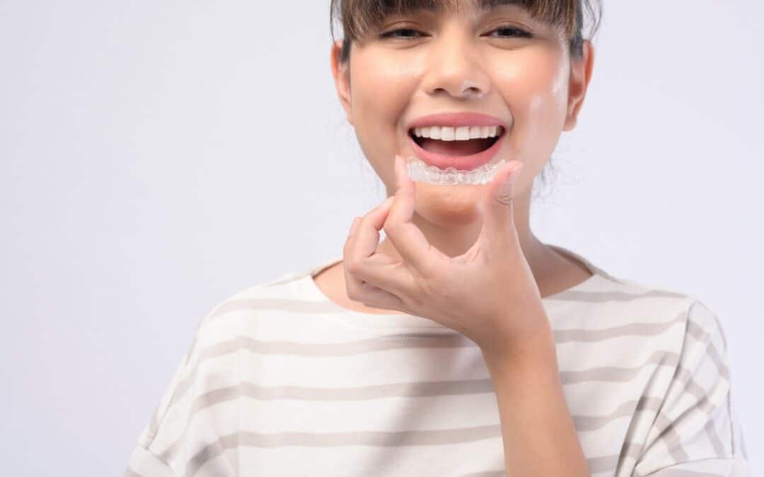 Woman holding an aligner