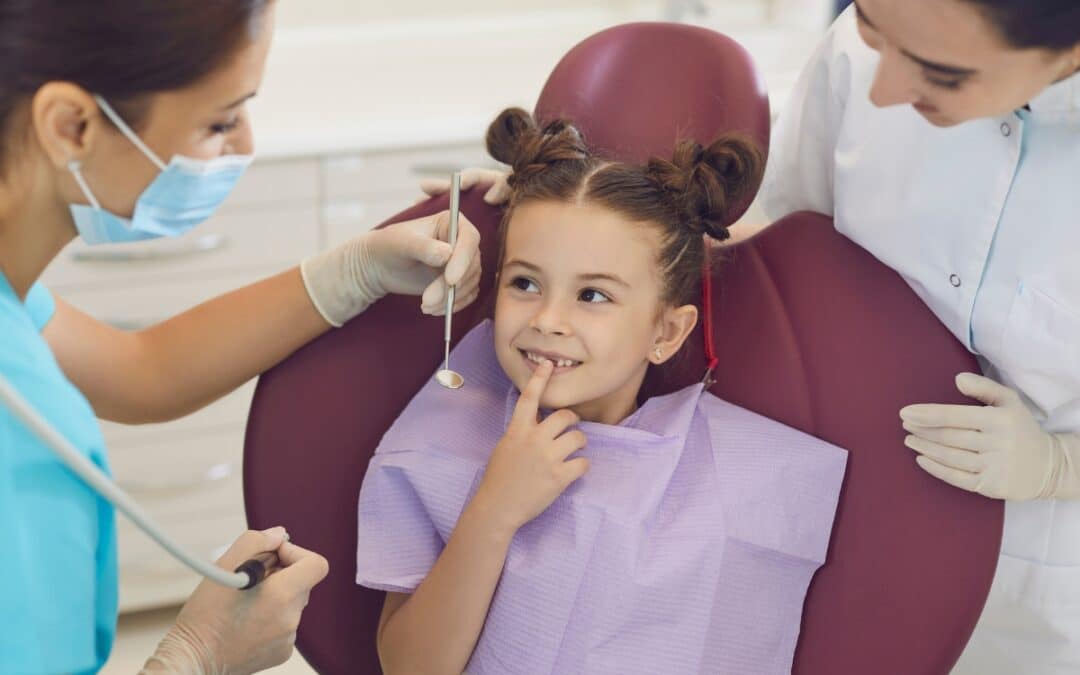 Dental professional examining child's teeth