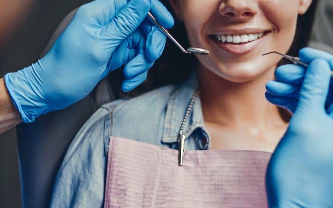 Dentist examining woman's teeth