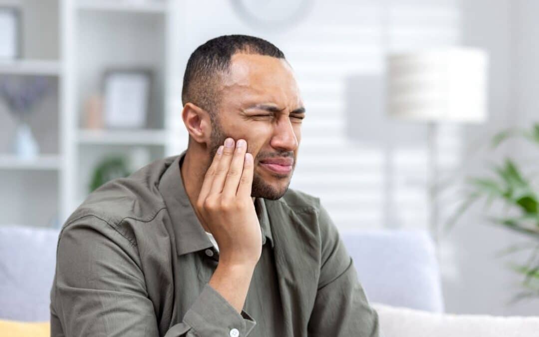 Man holding his jaw in pain
