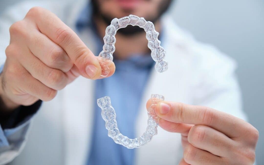 Dentist holding invisalign aligners